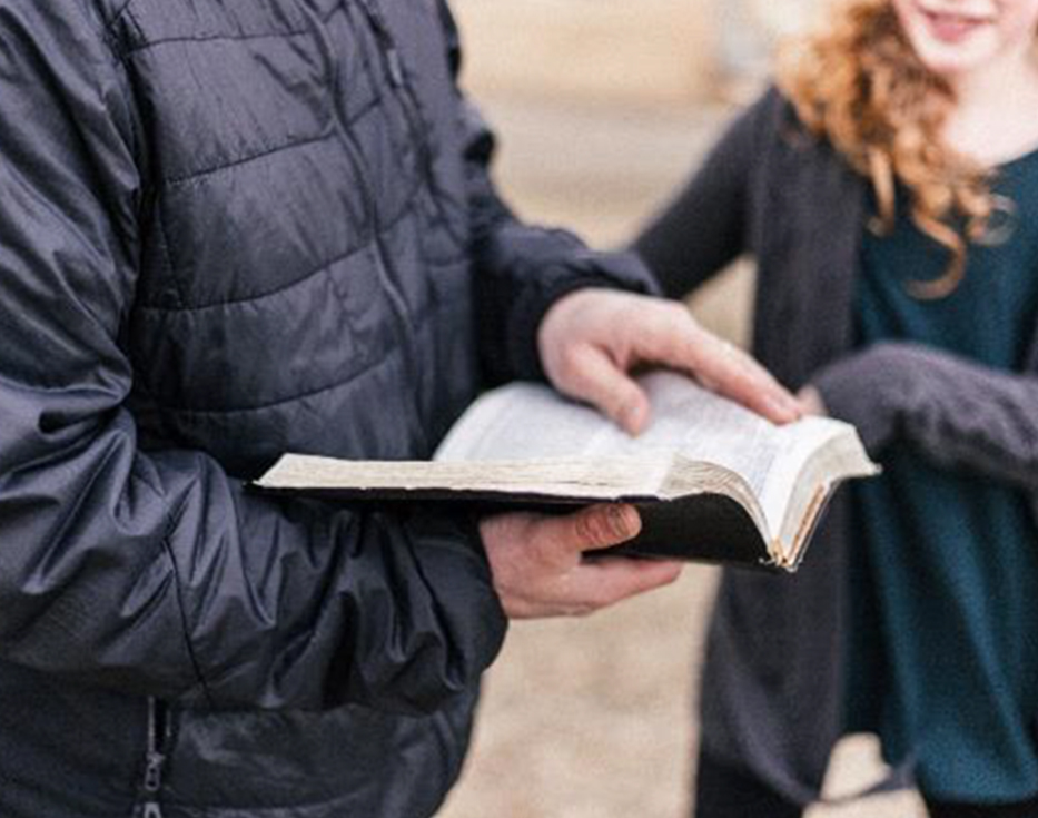 Israeli man holding and open Bible in his hands