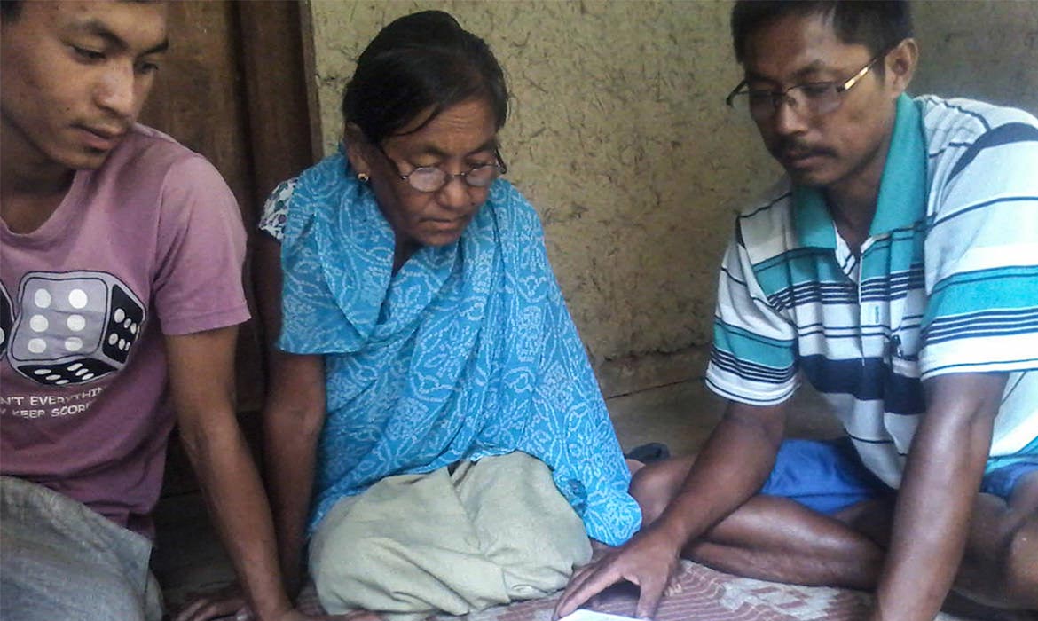 3 South Asian Christians sit on the floor reading the Bible together